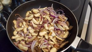 stir-fry red onion and shitake to make this Yummy Japchae Recipe